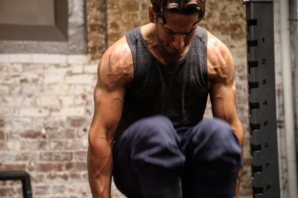 Mike Simone Performing Knee Tuck Exercise